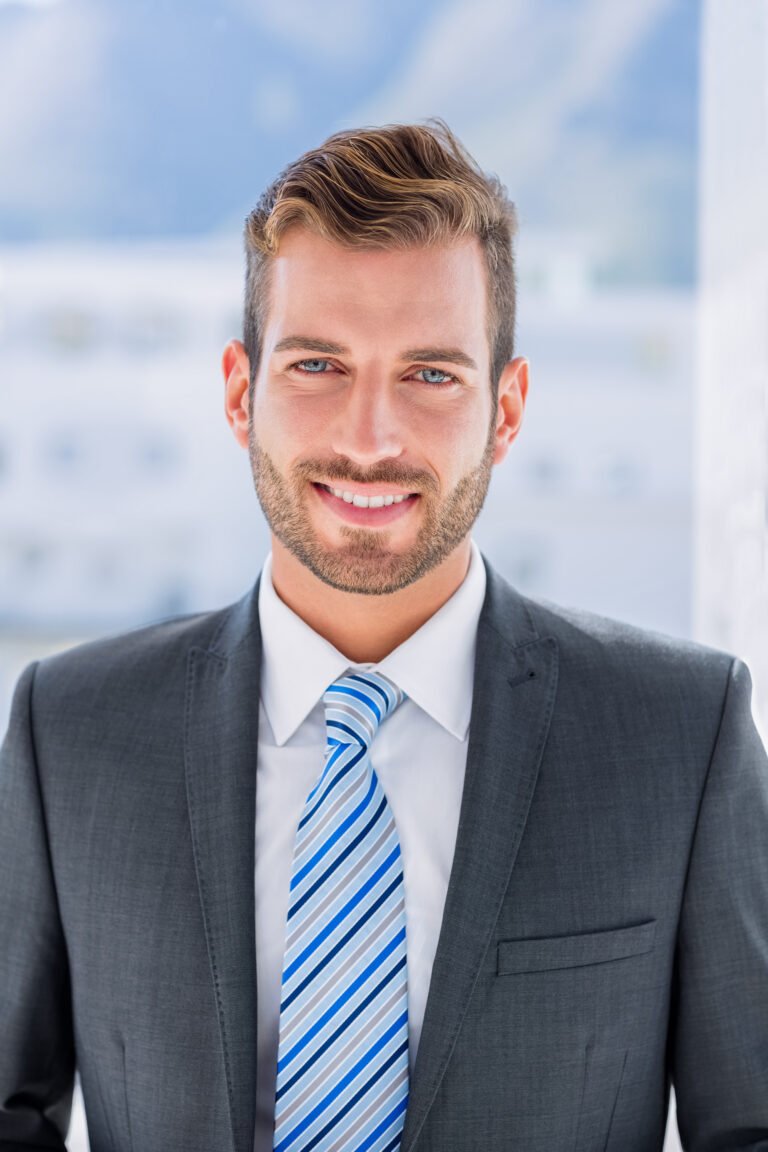 Portrait of a handsome young businessman over blurred background in office